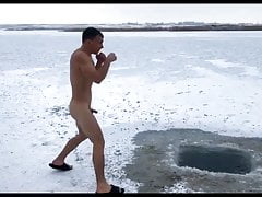 Naked boxer exercises on a frozen lake
