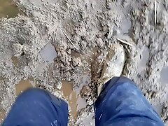 Walking in mud wearing rubber boots, getting stuck